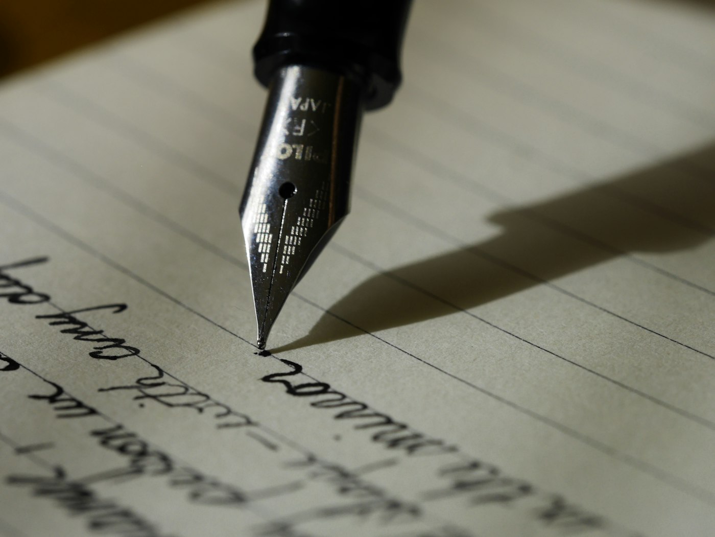 Fountain pen on lined paper, the kind of packet notes a hearing file starts as.