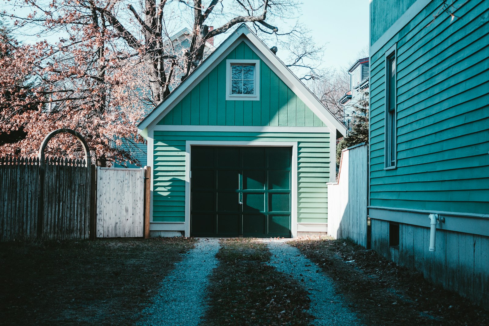 A green clapboard garage on a residential lot in Providence, Rhode Island.